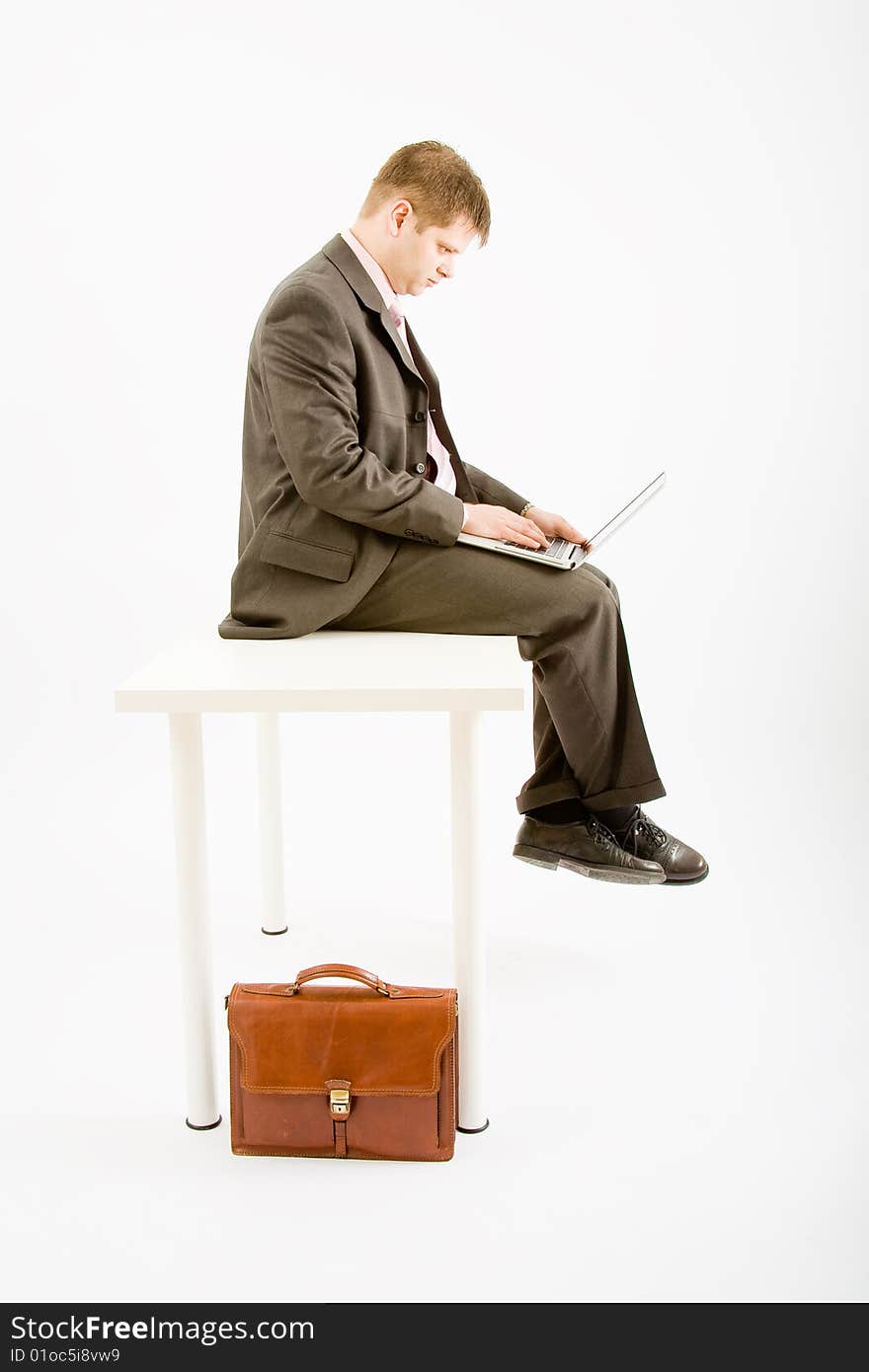 Young business man with laptop computer on white background