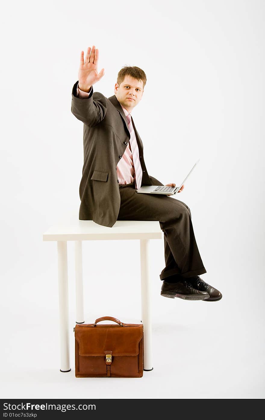 Young business man with laptop computer on white background