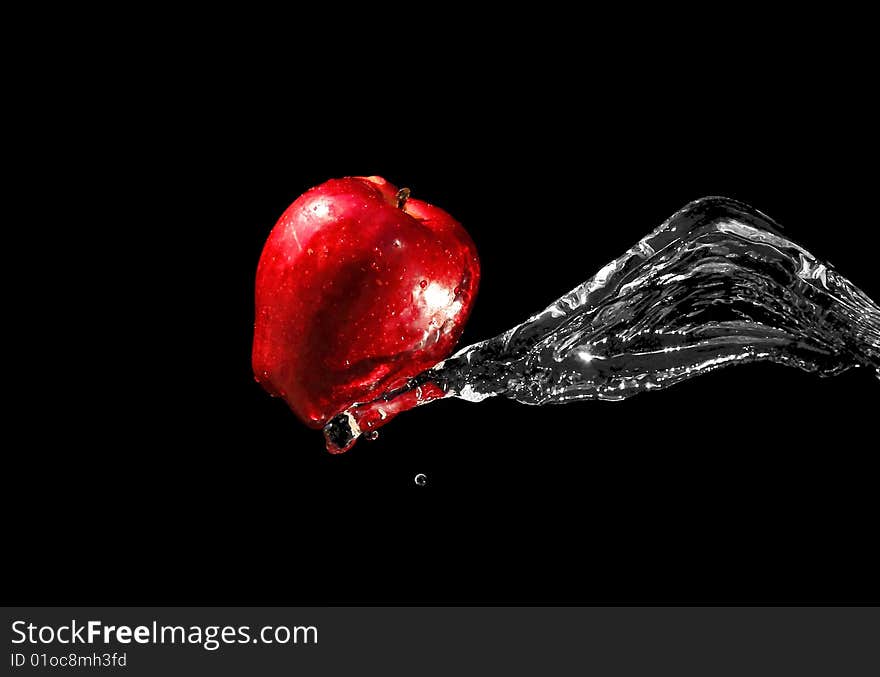 Red ripe apple in water stream. Red ripe apple in water stream