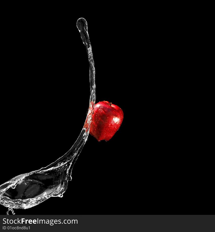 Red apple and water stream close to it