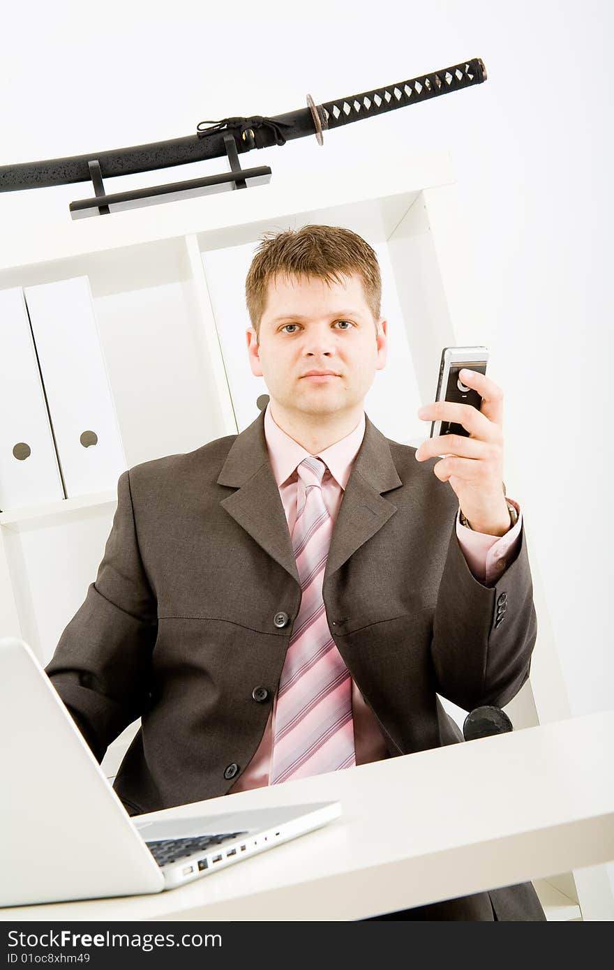 Young businessman working with phone and laptop computer