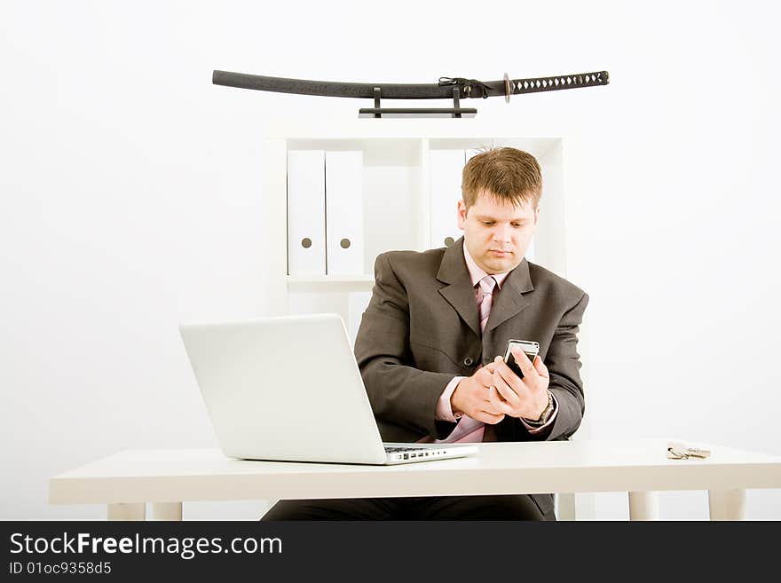 Young businessman working with phone and laptop computer