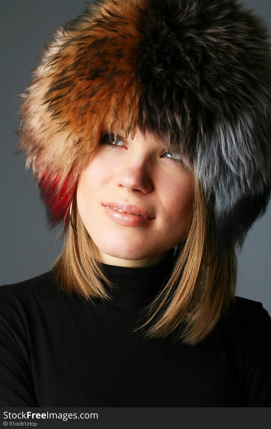 Portrait of a beautiful woman in a fur hat