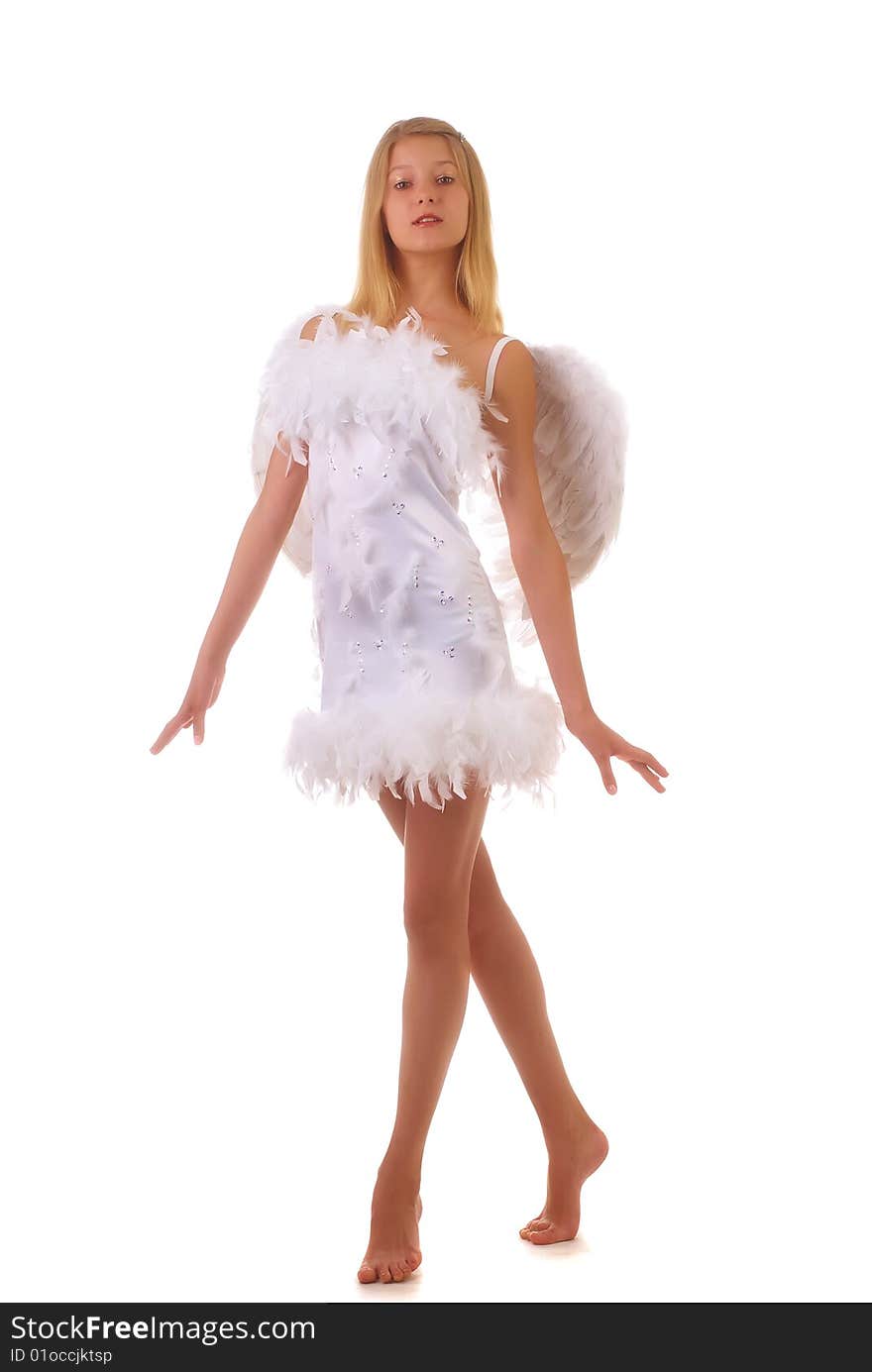 Young beautiful girl in a white dress with wings behind the back on a white background. Young beautiful girl in a white dress with wings behind the back on a white background