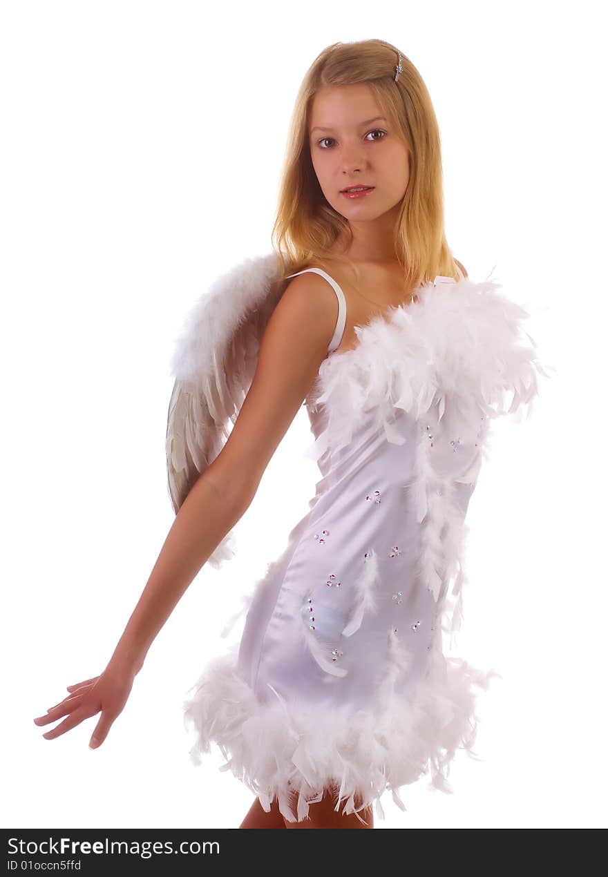 Young beautiful girl in a white dress with wings behind the back on a white background. Young beautiful girl in a white dress with wings behind the back on a white background