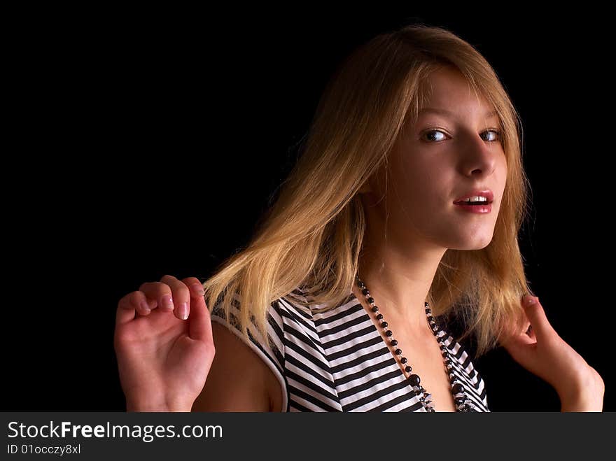 Beautiful portrait of a young girl with expressive eyes on the black background. Beautiful portrait of a young girl with expressive eyes on the black background