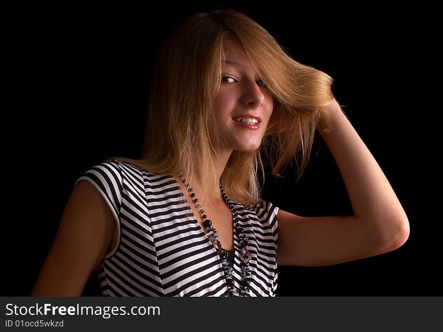 Beautiful portrait of a young girl with expressive eyes on the black background. Beautiful portrait of a young girl with expressive eyes on the black background