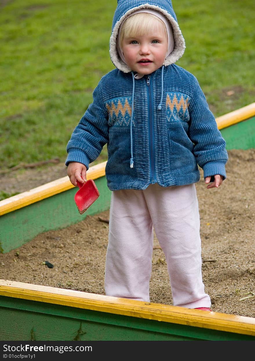 Little child stands with shovel. Little child stands with shovel