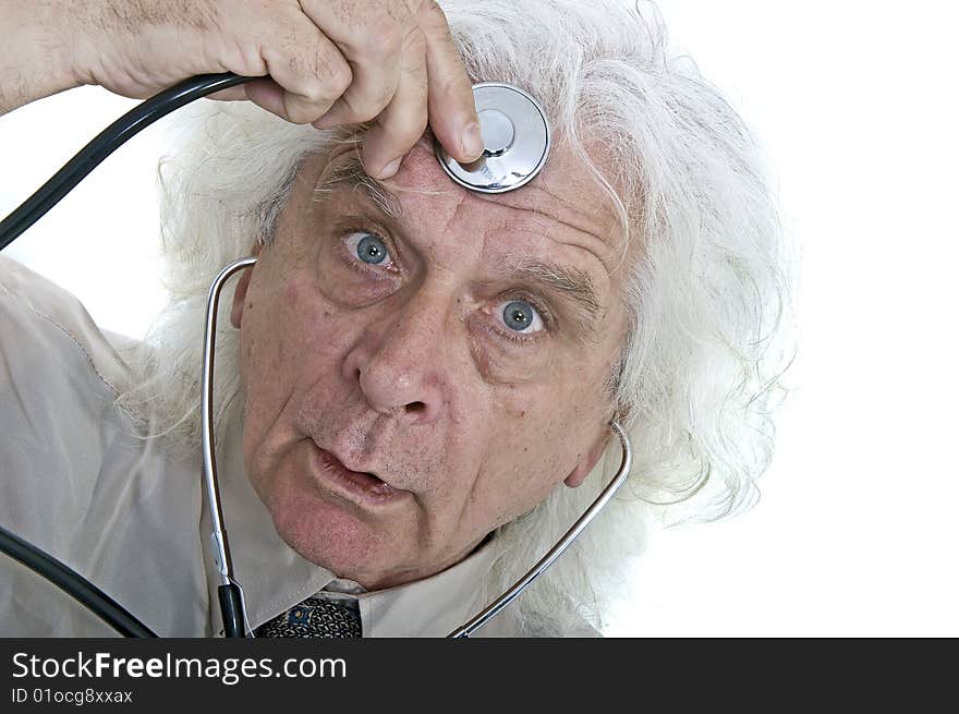 Older man checking his head with a stethoscope