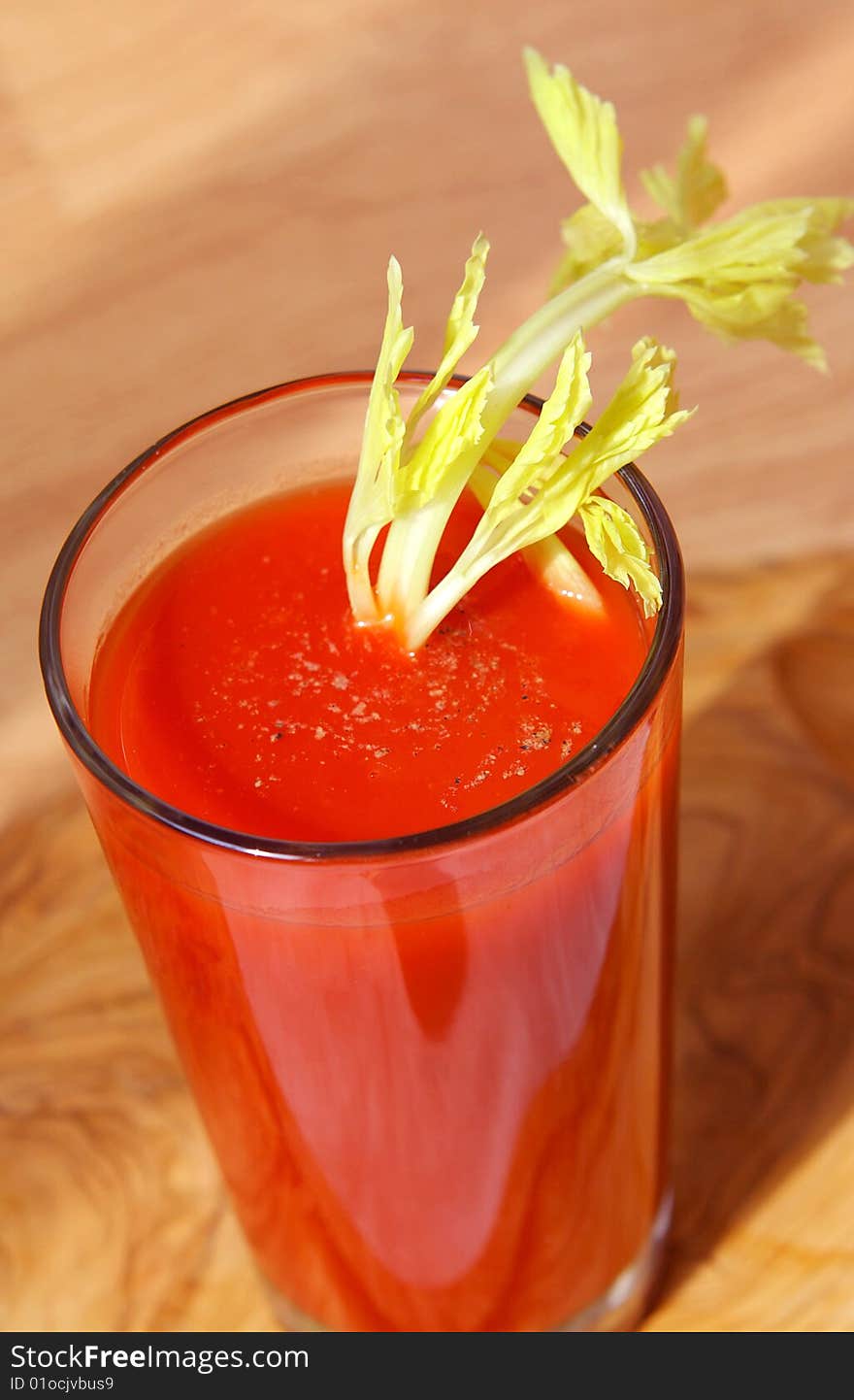 Tomato juice in a glass with a celery