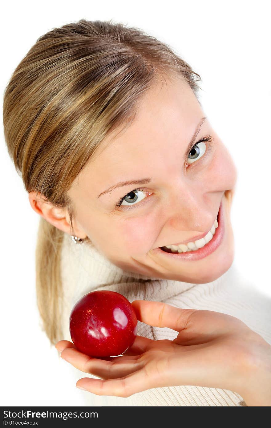 Female holding a fruit in her hand and smlling (healthy lifestyle concept). Female holding a fruit in her hand and smlling (healthy lifestyle concept)