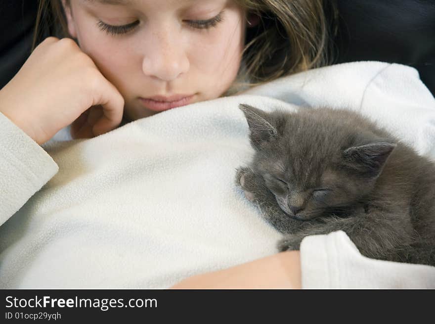 Young girl waits patiently for her new kitten to wake. Young girl waits patiently for her new kitten to wake