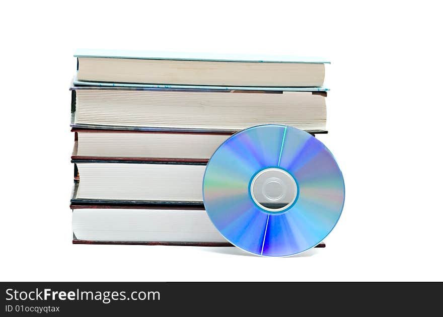 Pile of books and DVD disk as symbols of old and new methods of information storage