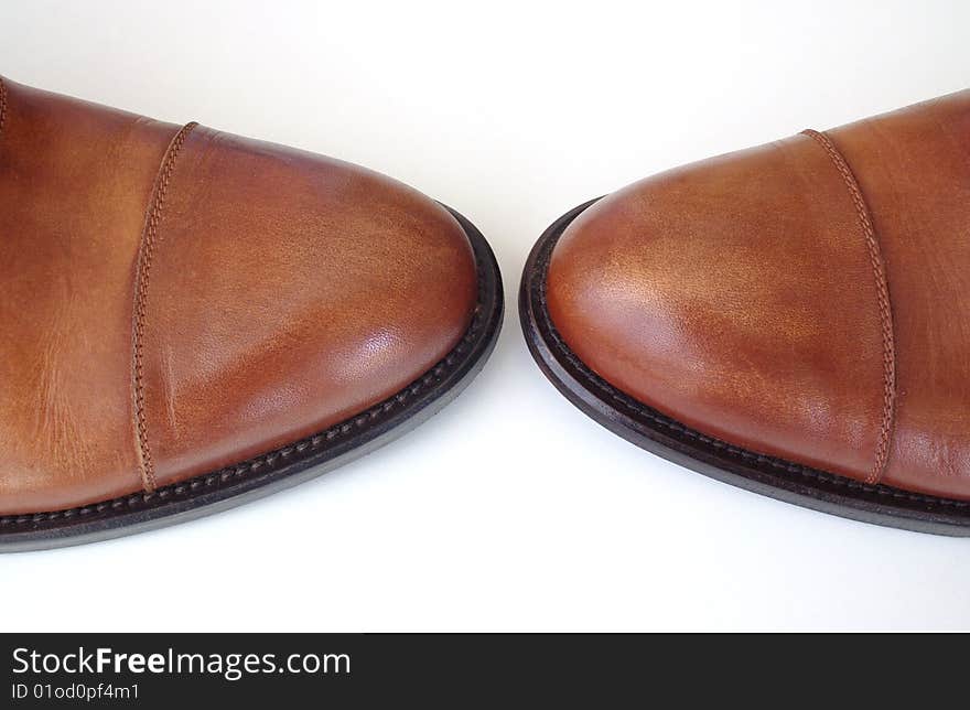 Pair of brown shoes on white