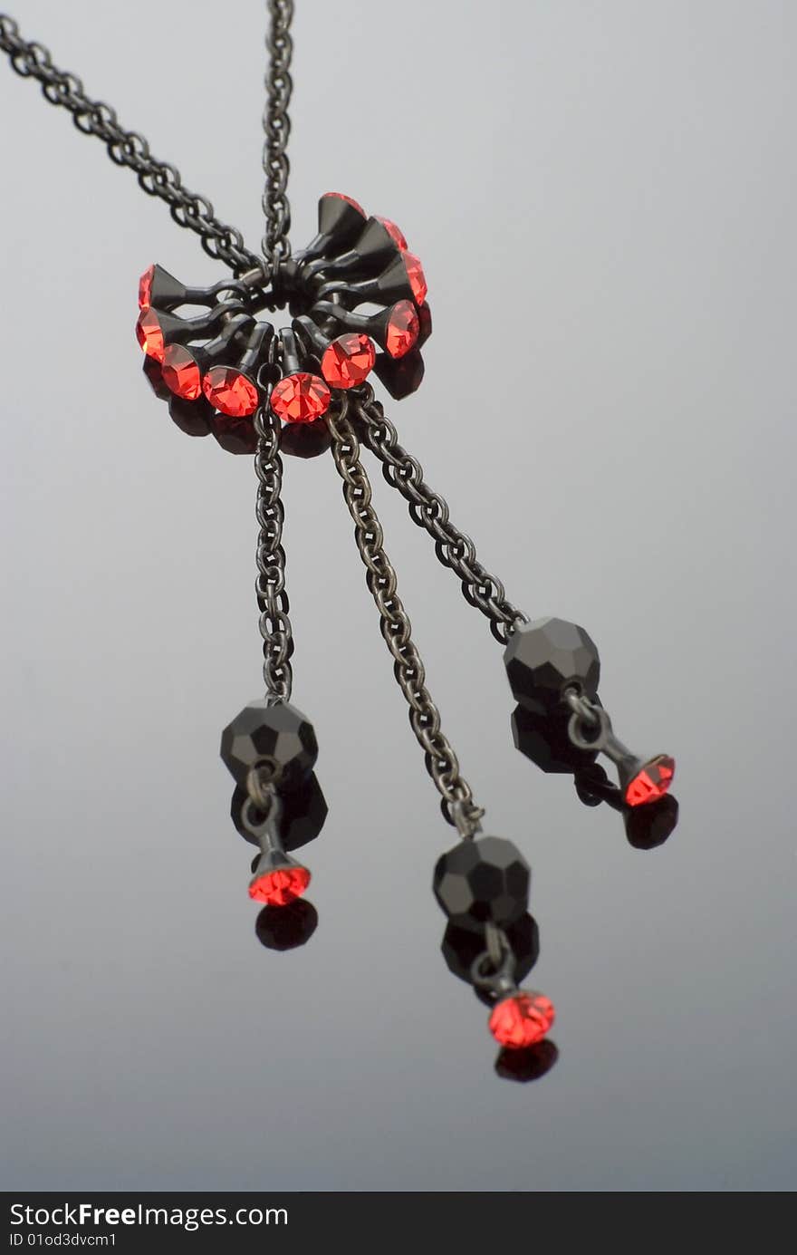 Close up of a modern black necklace with red gemstones. Close up of a modern black necklace with red gemstones