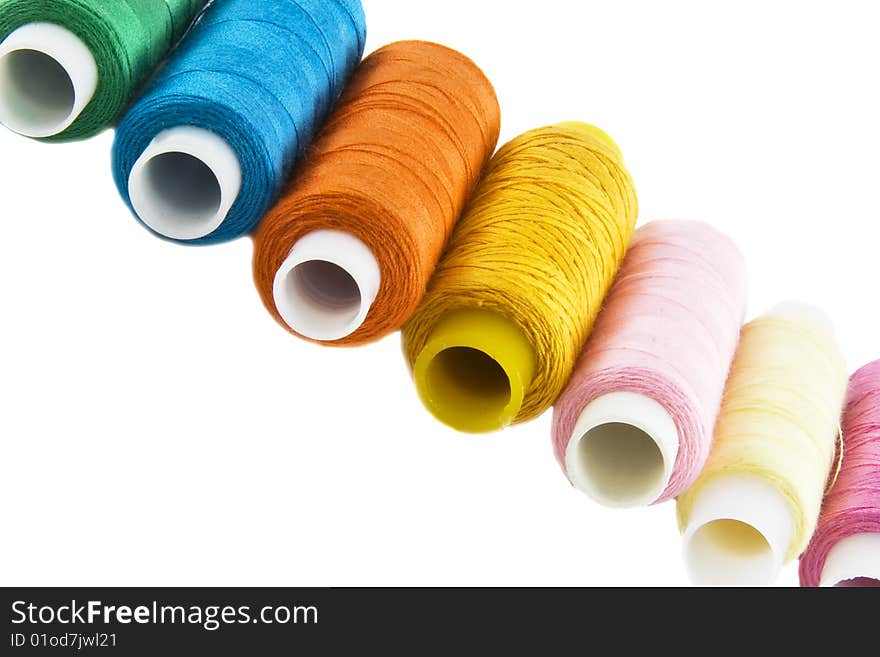 Many colorful threads over the white background
