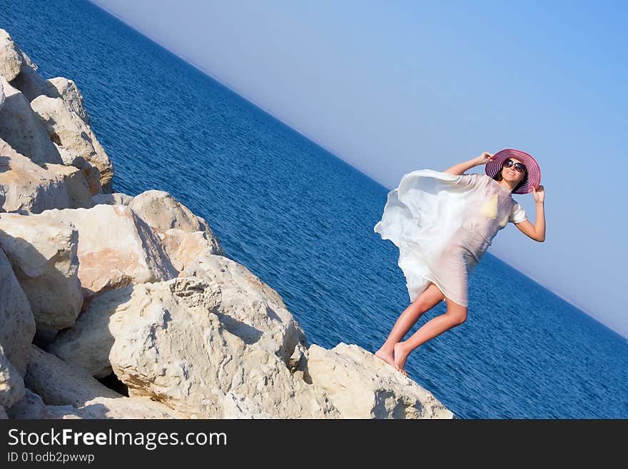 Portrait of the girl in white sarong standing on the big stone