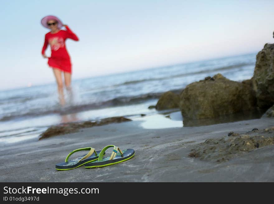 Young happy girl runs on coast