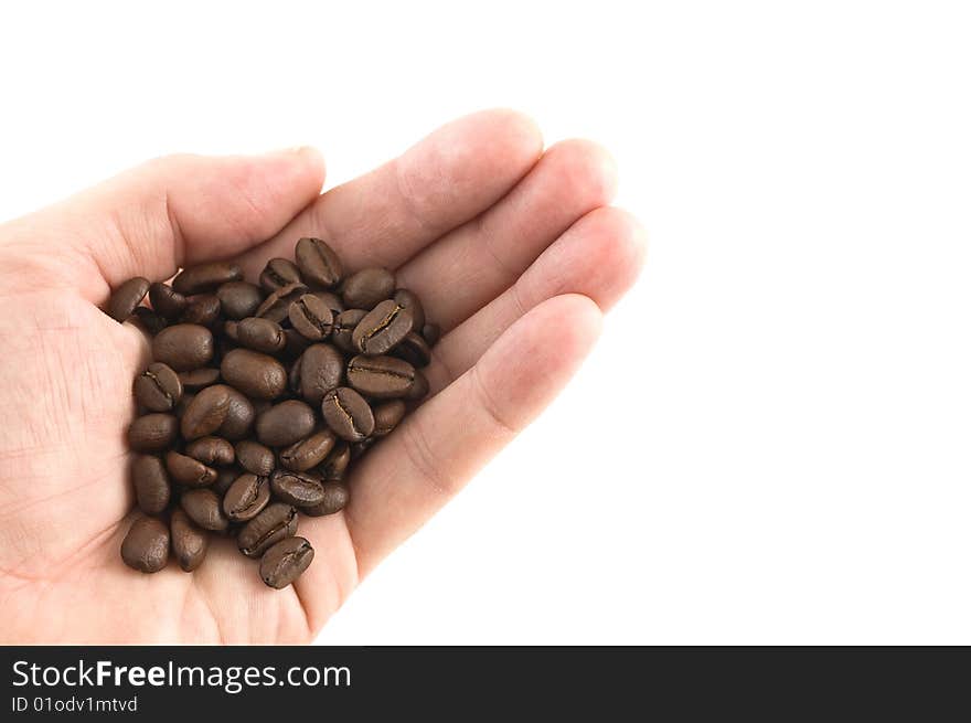 Handful of coffee beans, white background, close up.