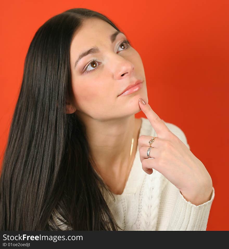 Portrait of the young girl on a red background