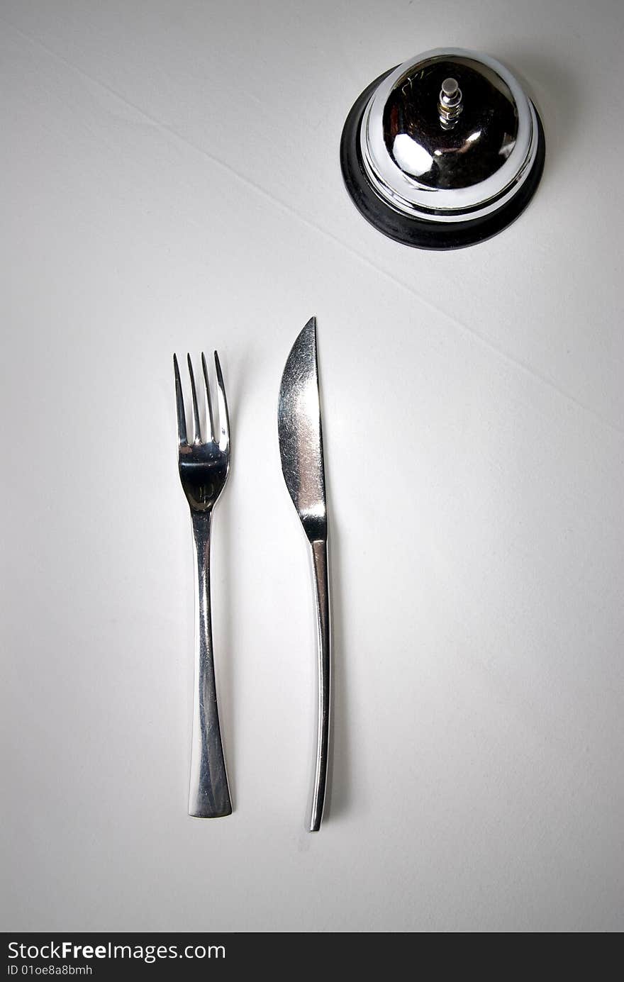 Fork and knife on table with restaurant ring. Fork and knife on table with restaurant ring