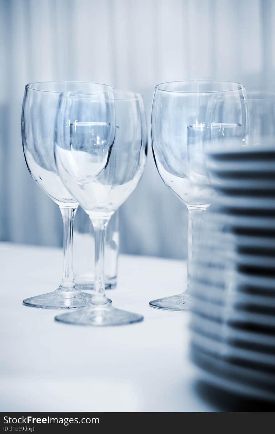 Glass goblets and plates on the table