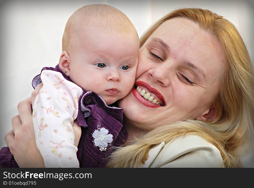 Family picture of playful mother and baby girl. Family picture of playful mother and baby girl.