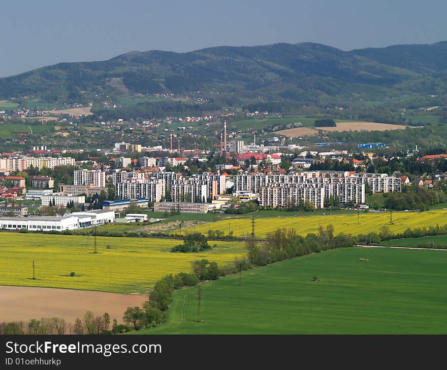 Landscape of Czech country and town under hills