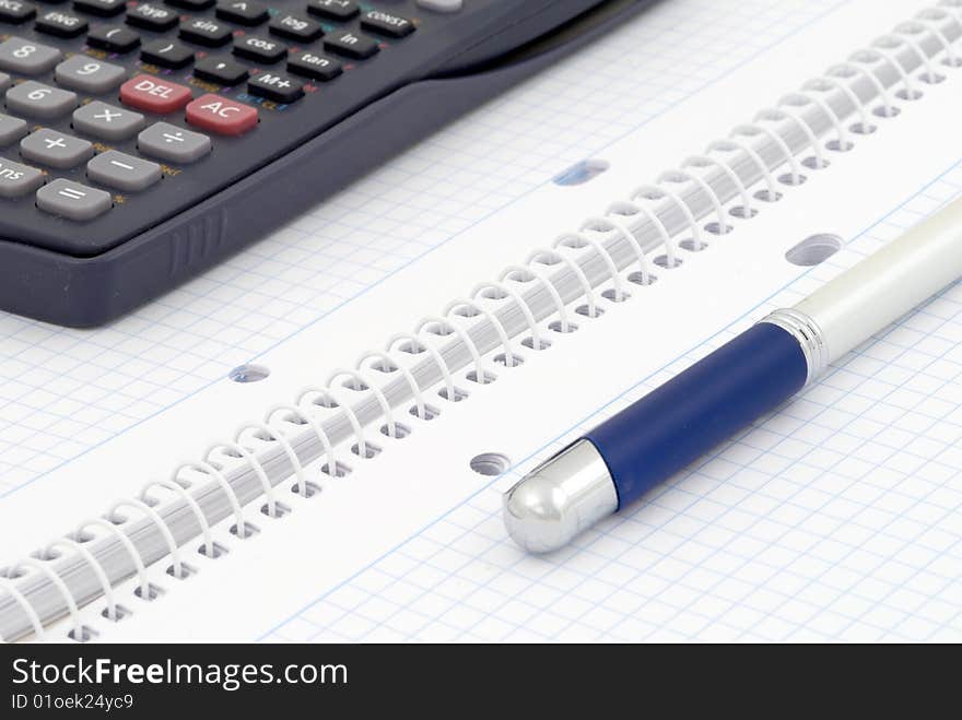 Business background. Spiral notebook with blue grid. Selective focus. Business background. Spiral notebook with blue grid. Selective focus