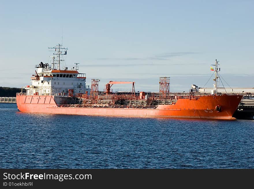 Large container ship in a dock at Klaipeda (Lithuania) harbor (logos and brandnames systematically removed). Large container ship in a dock at Klaipeda (Lithuania) harbor (logos and brandnames systematically removed)