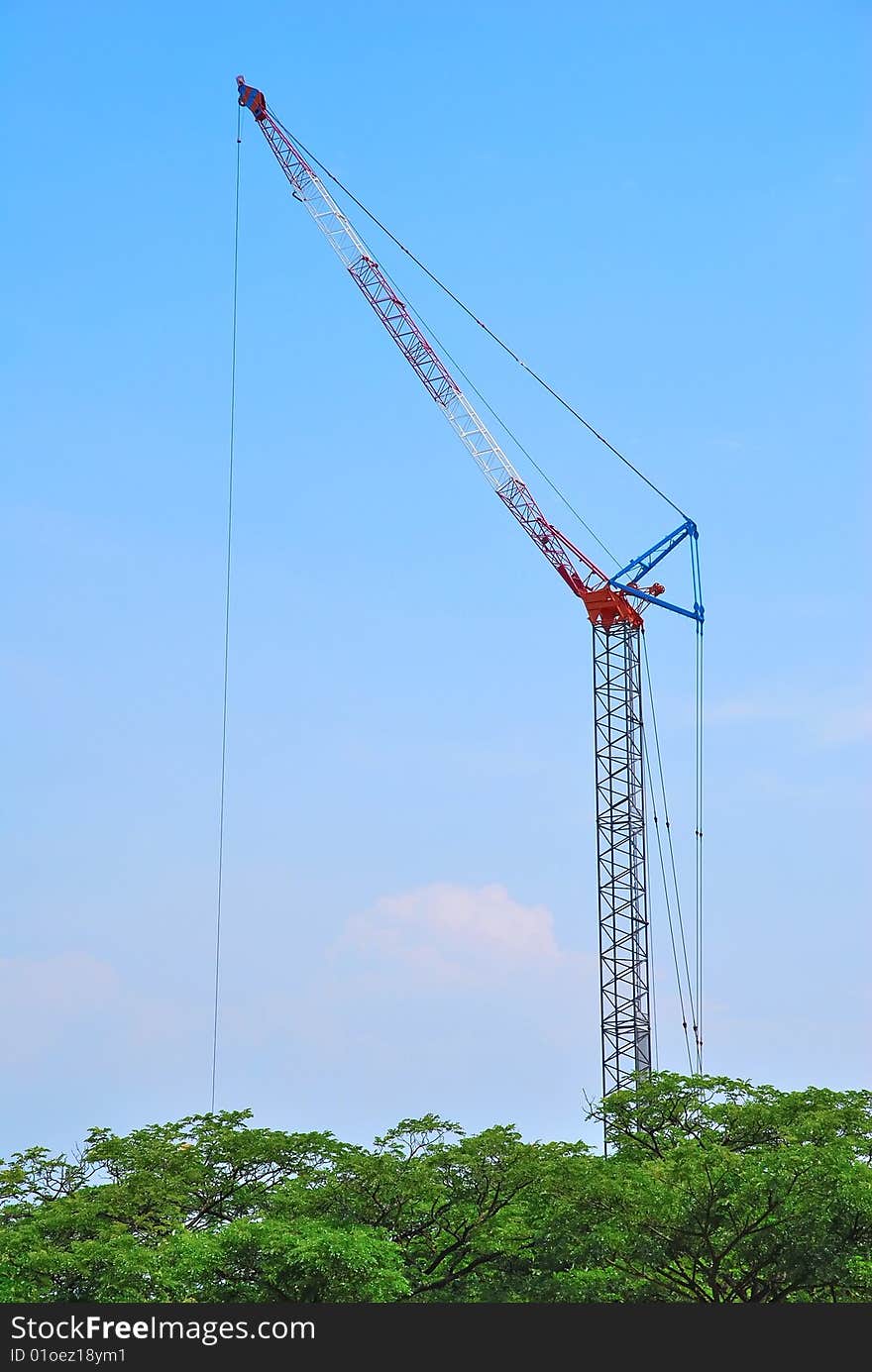 Huge, isolated construction crane towering above the trees. Huge, isolated construction crane towering above the trees