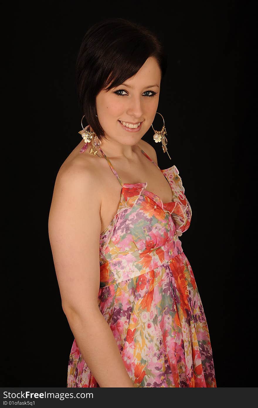 A formal portrait of a dark haired teenage girl. Black background. A formal portrait of a dark haired teenage girl. Black background