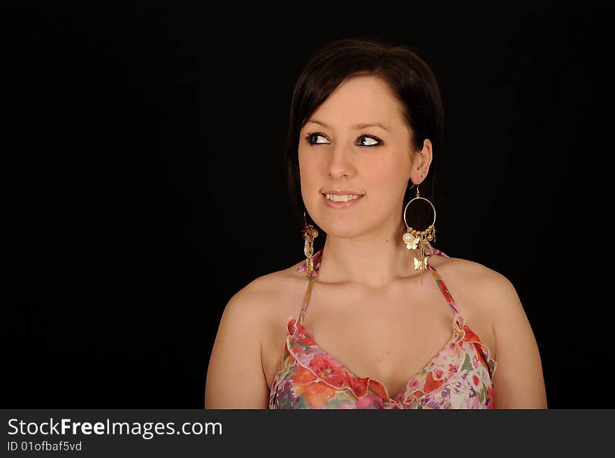 Horizontal closeup portrait of a smiling young woman, isolated against a black background. Horizontal closeup portrait of a smiling young woman, isolated against a black background.