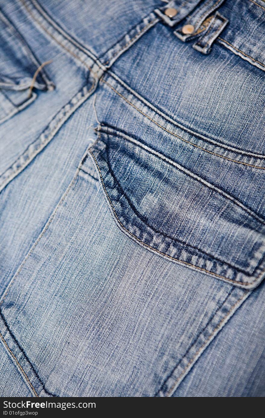 Old blue jeans with pocket and button