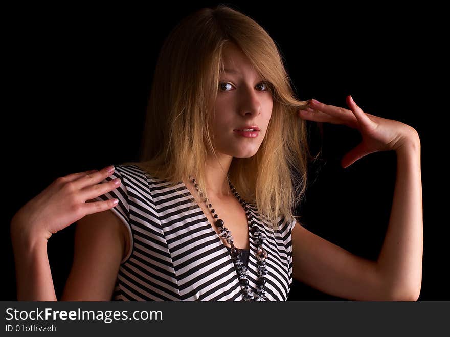 Beautiful portrait of a young girl with expressive eyes on the black background. Beautiful portrait of a young girl with expressive eyes on the black background