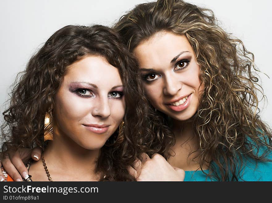 Portrait of two young happy women in bright clothing. Portrait of two young happy women in bright clothing.