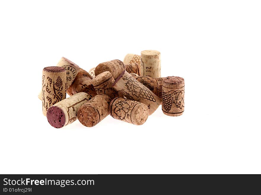 Stoppers from bottles with wine of different grades on a white background