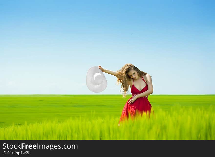 woman enjoying summertime in green field. woman enjoying summertime in green field