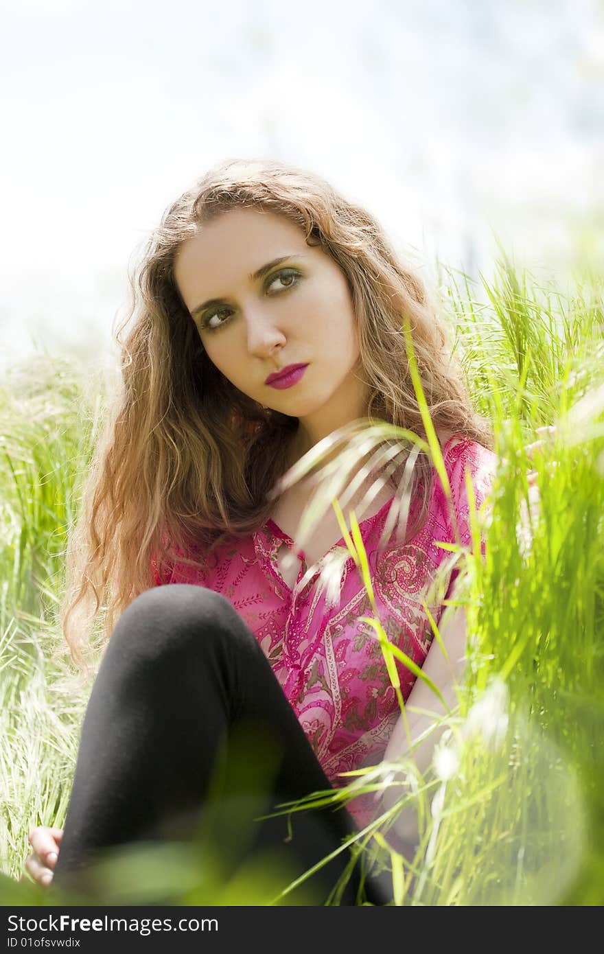 beautiful woman lying on green grass relaxing in summer. beautiful woman lying on green grass relaxing in summer