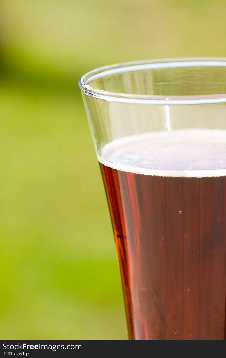 Black beer on green background