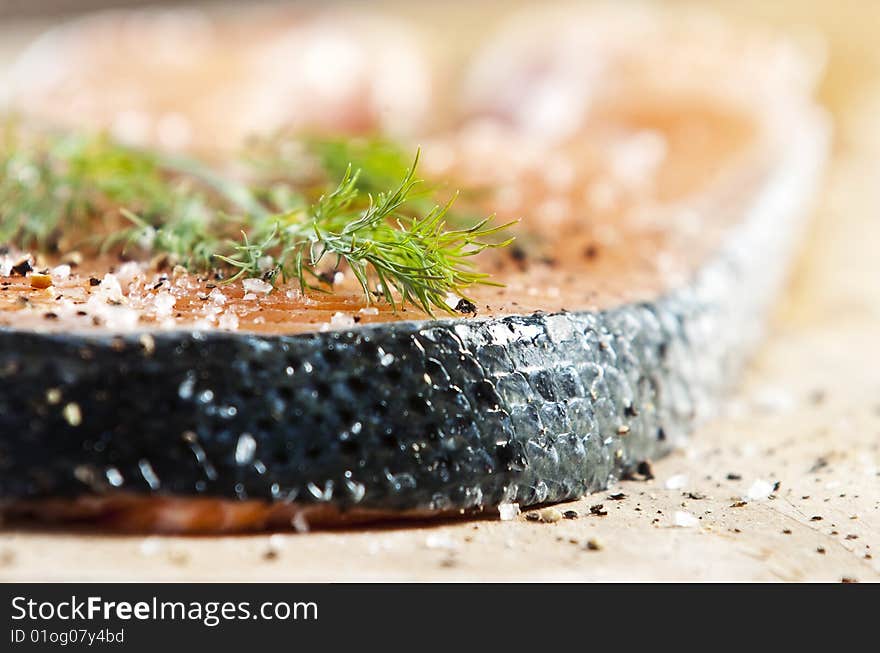 Raw salmon fillet on an old wooden kitchen board