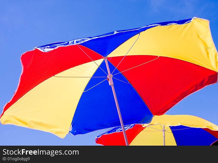 Sunshade on background of the blue sky