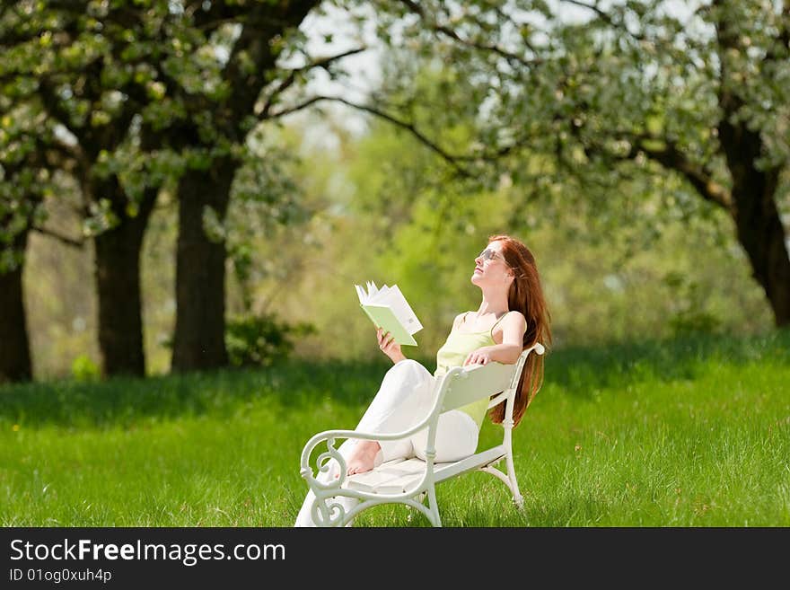 Woman relax under blossom tree in summer