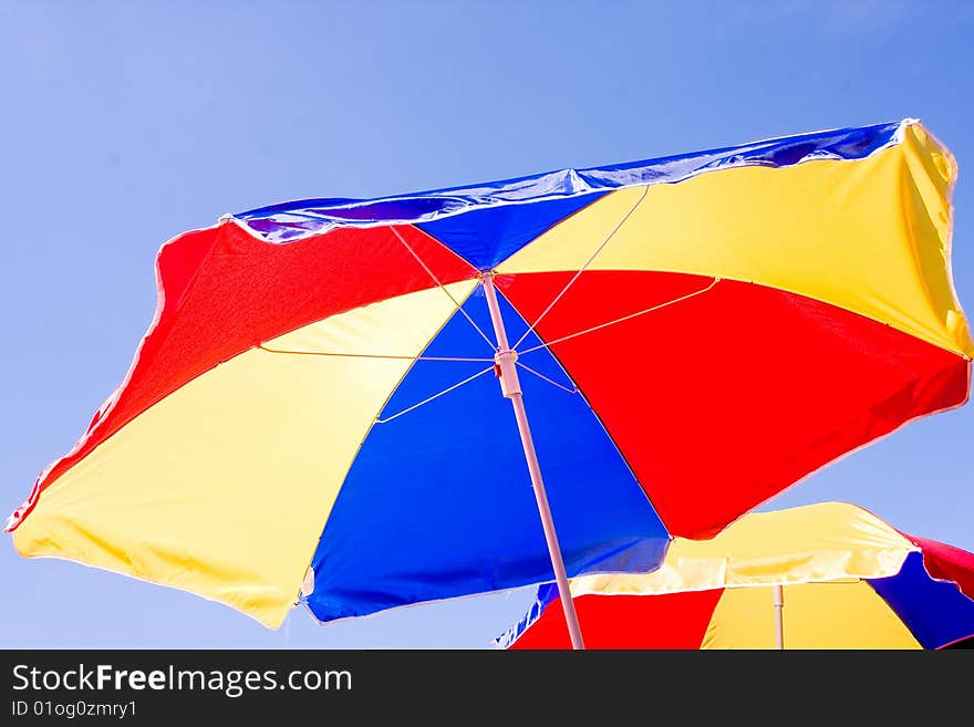 Sunshade on background of the blue sky