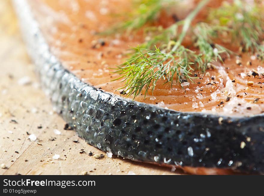 Raw salmon fillet on an old wooden kitchen board