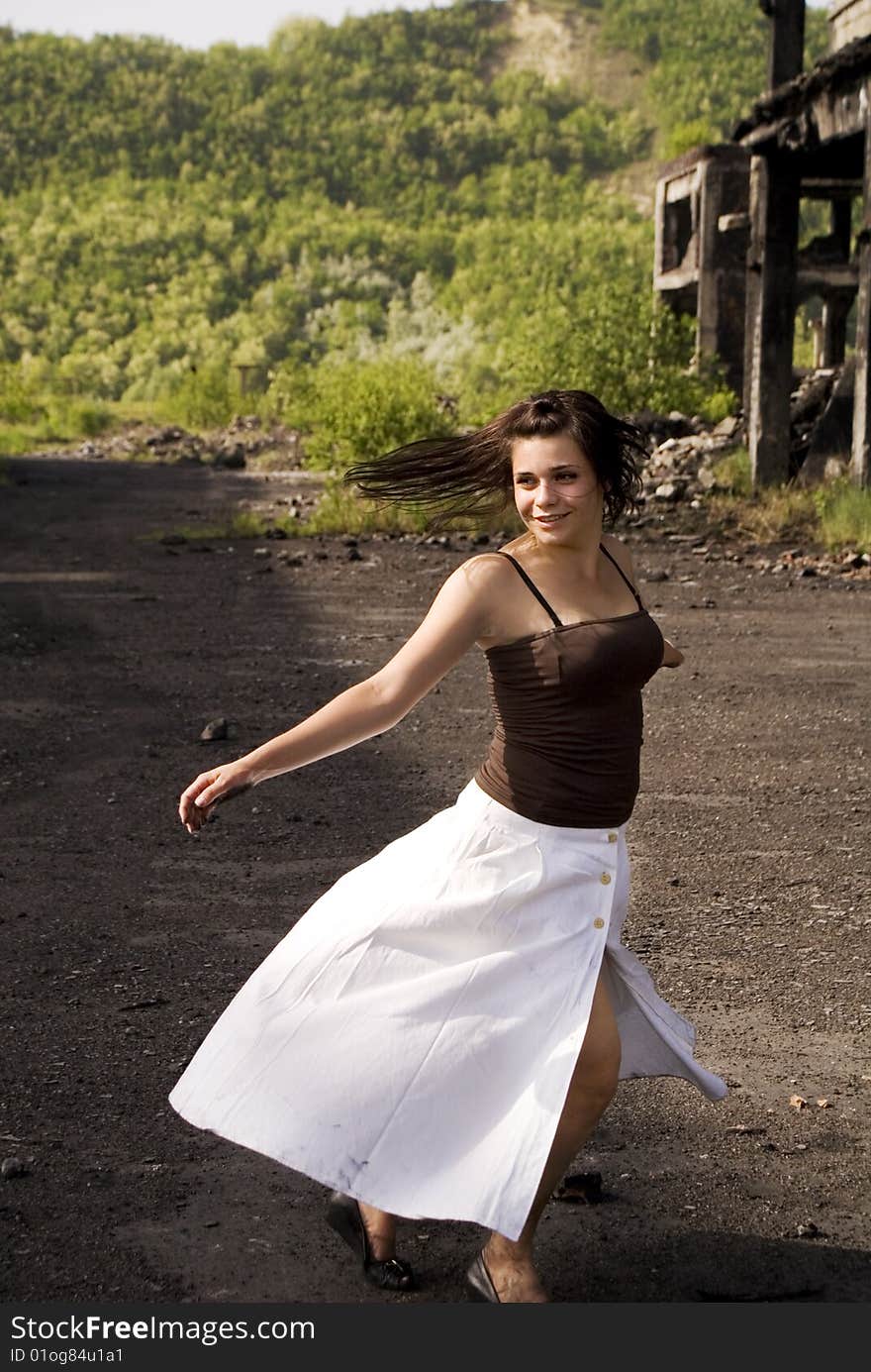 Young happy woman in a white dress dancing. Young happy woman in a white dress dancing