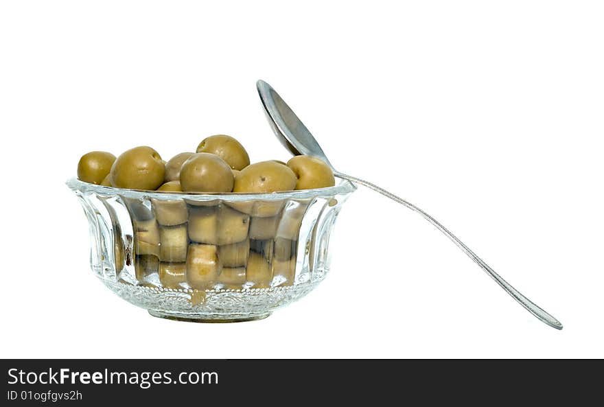 Green olives and spoon isolated on white background