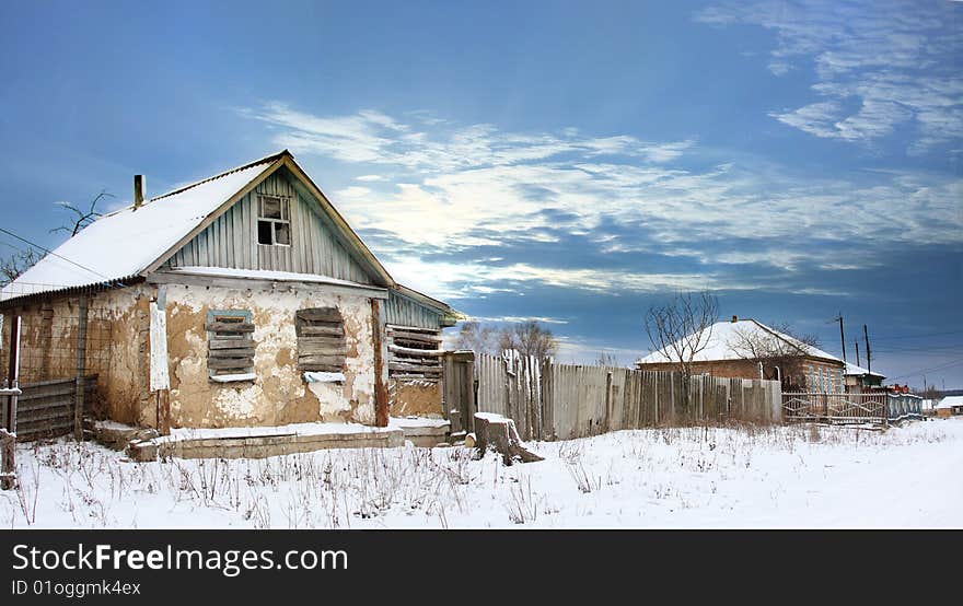 Destroy house in snow under blue sky