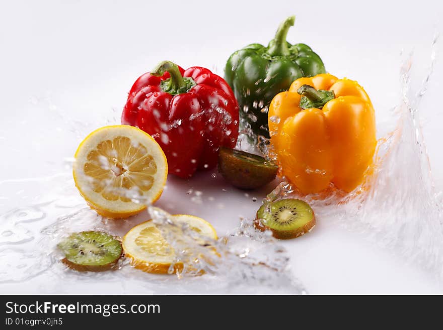 Lemon, pepper and kiwi in water. Lemon, pepper and kiwi in water