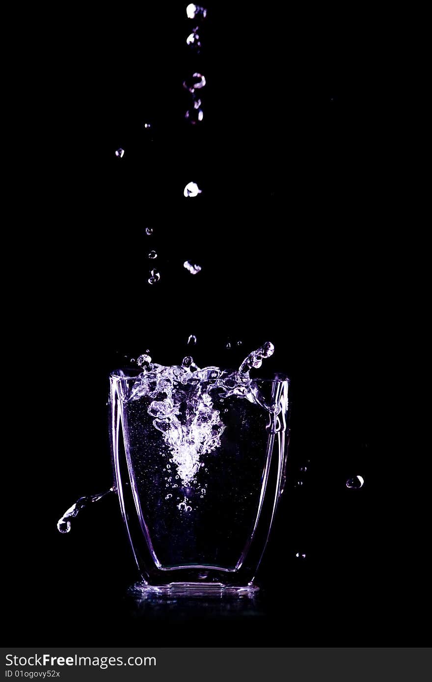 Water drops flow into glass